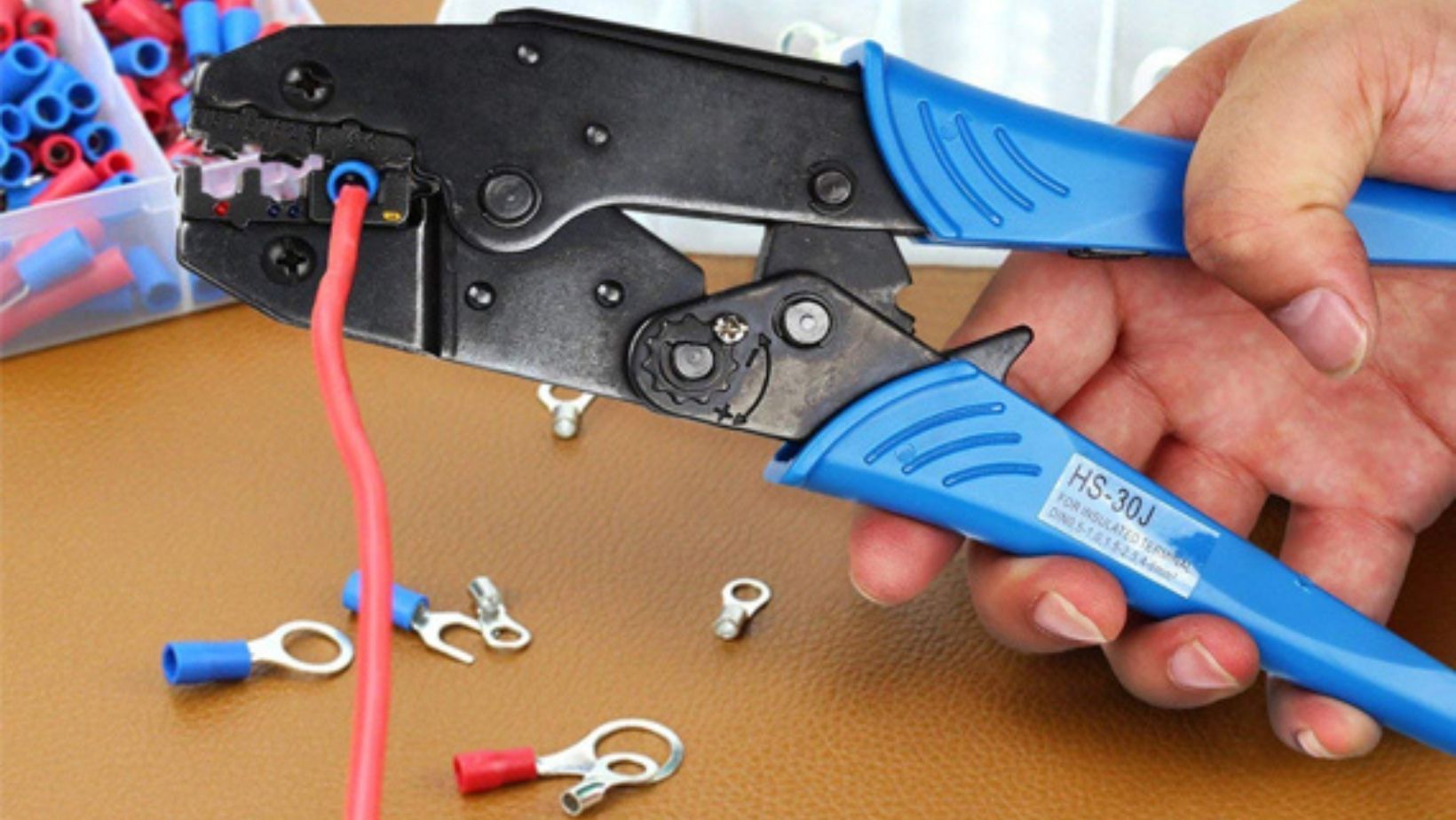 An electrician crimping a cable