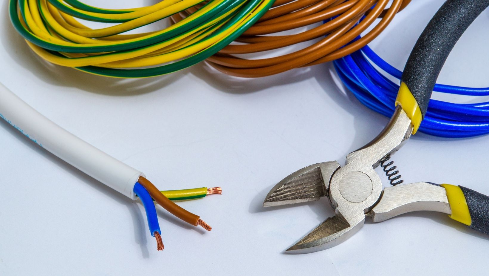 An electrical crimping pliers and electrical wires on a floor