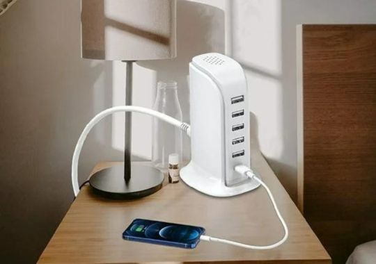 A phone on the 40W Upoy wall charger block- the ultimate charging station.