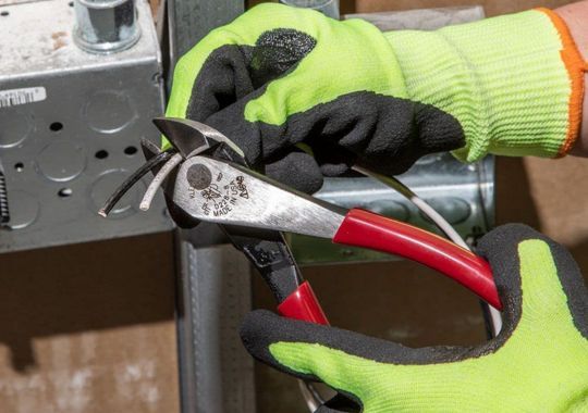 A person with a klein pliers diagonal cutter.