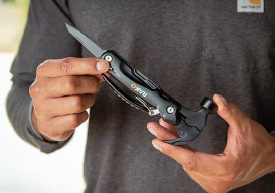 A person holding the Rak hammer multitool.