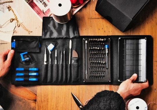 A person folding the ifixit pro tech toolkit