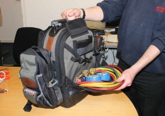 A man packing tools in a Veto Tool Bag.
