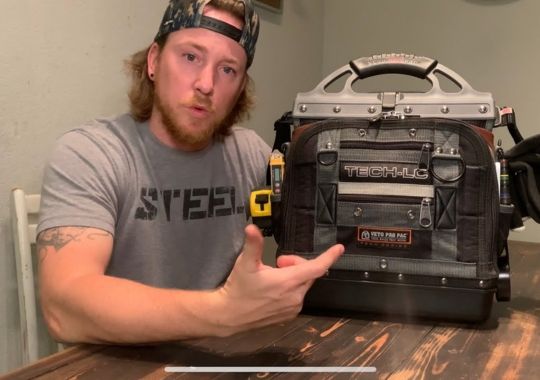 A man showing off a Veto Tool Bag.