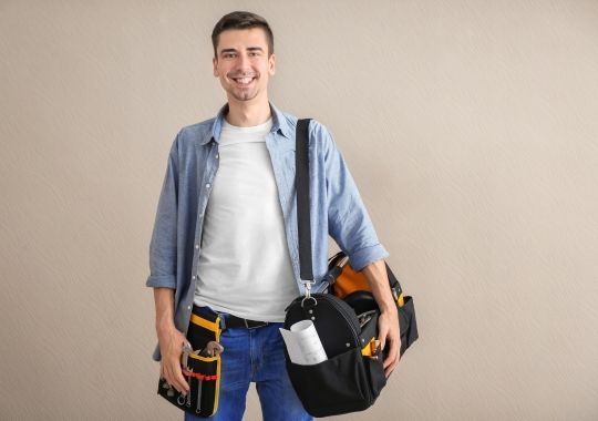 A man carrying a tool bag